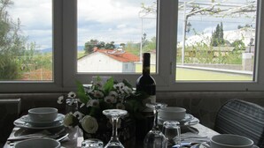 A dining table set for four with plates, bowls, wine glasses, and cutlery. - Beyaz Kale (Denizli)