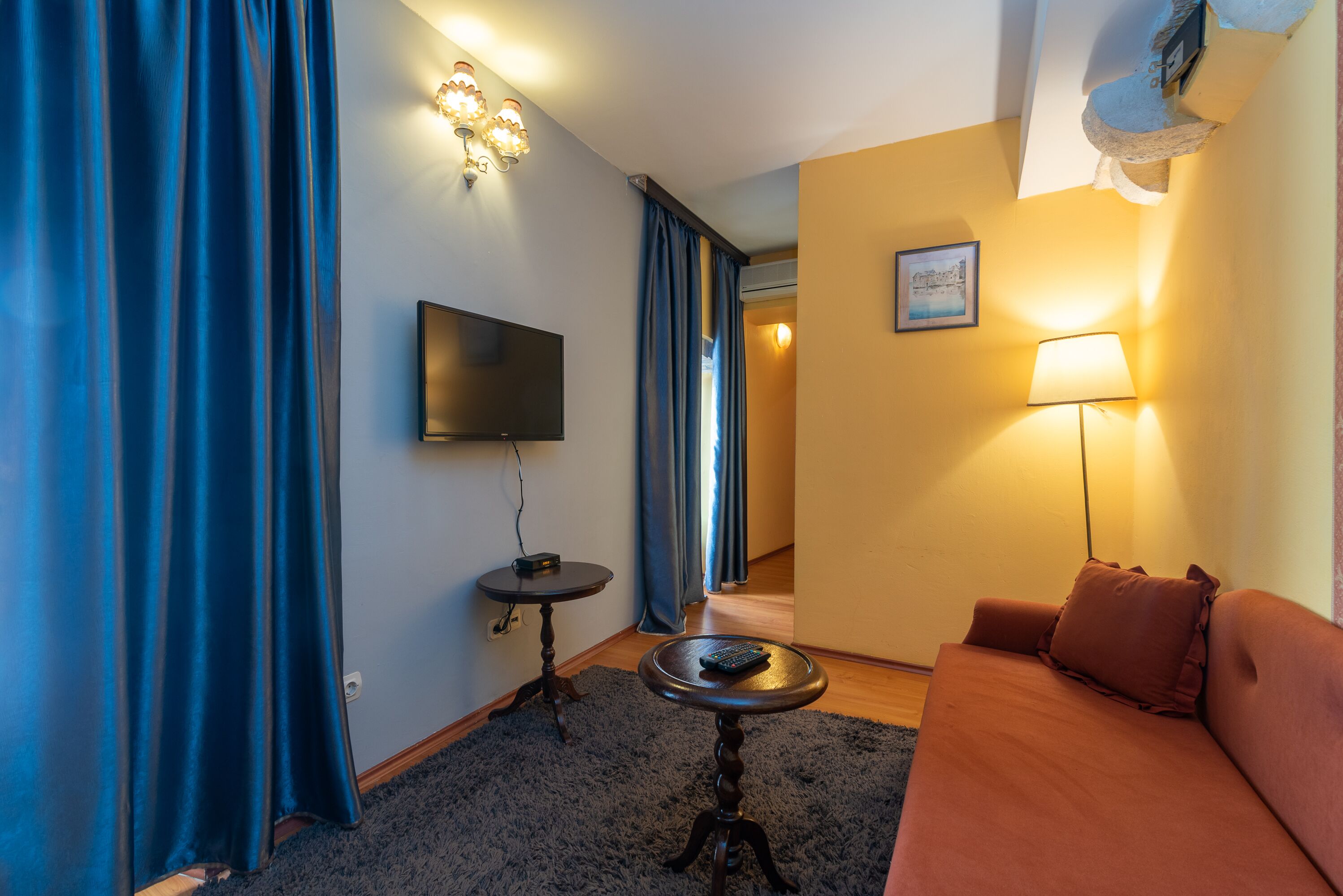 superior double room | living area | tv, dvd player, books