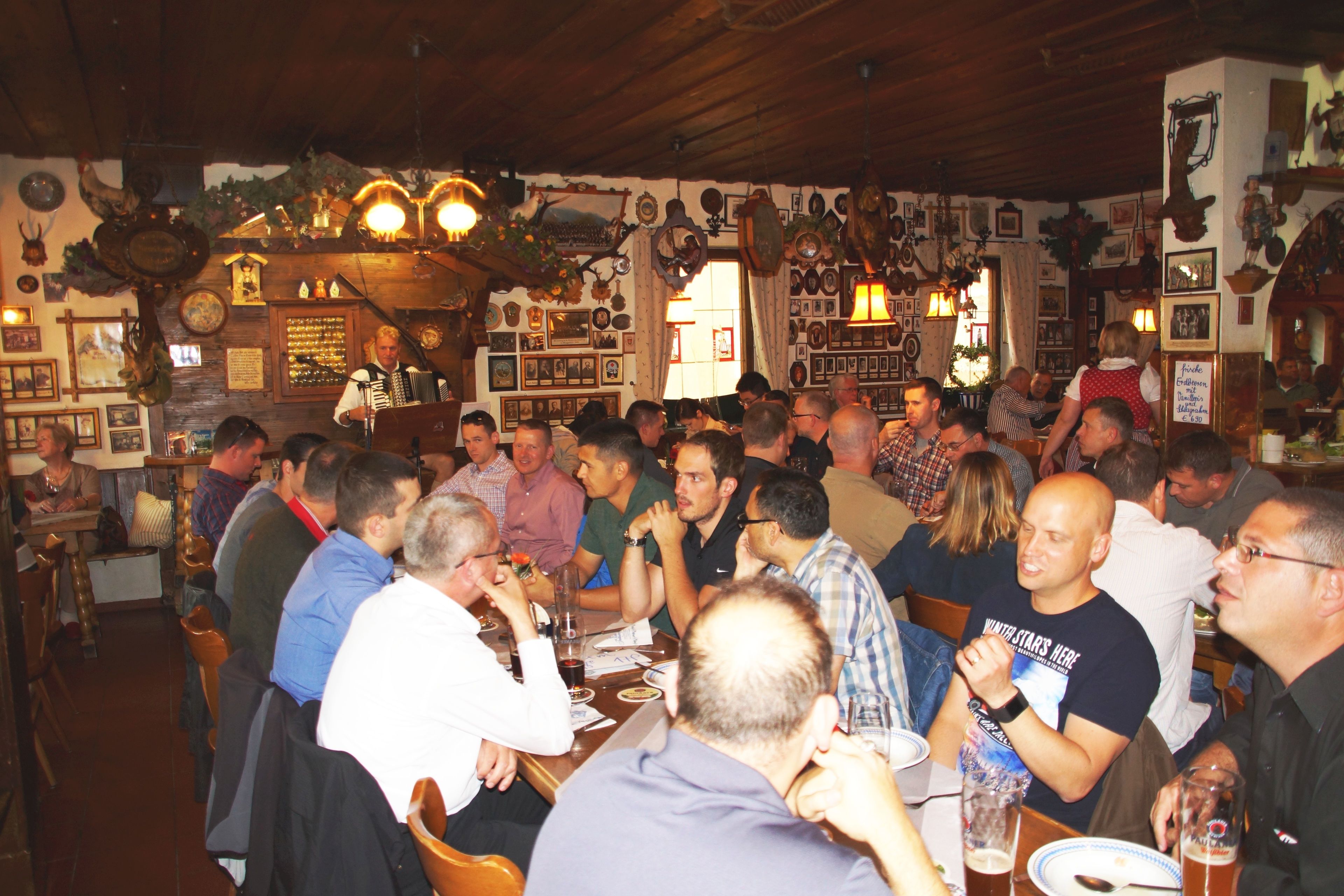 A crowded bar with wooden interiors and various decorations.