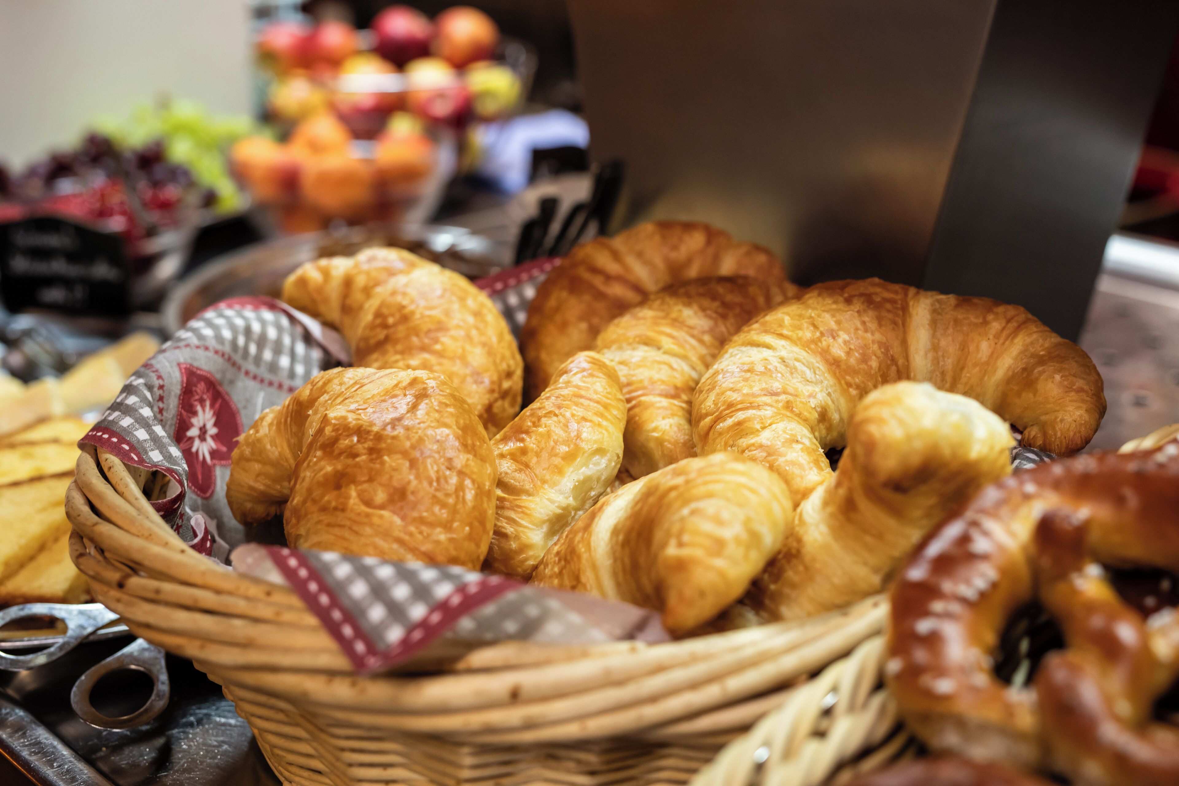 A basket of croissants and other pastries.