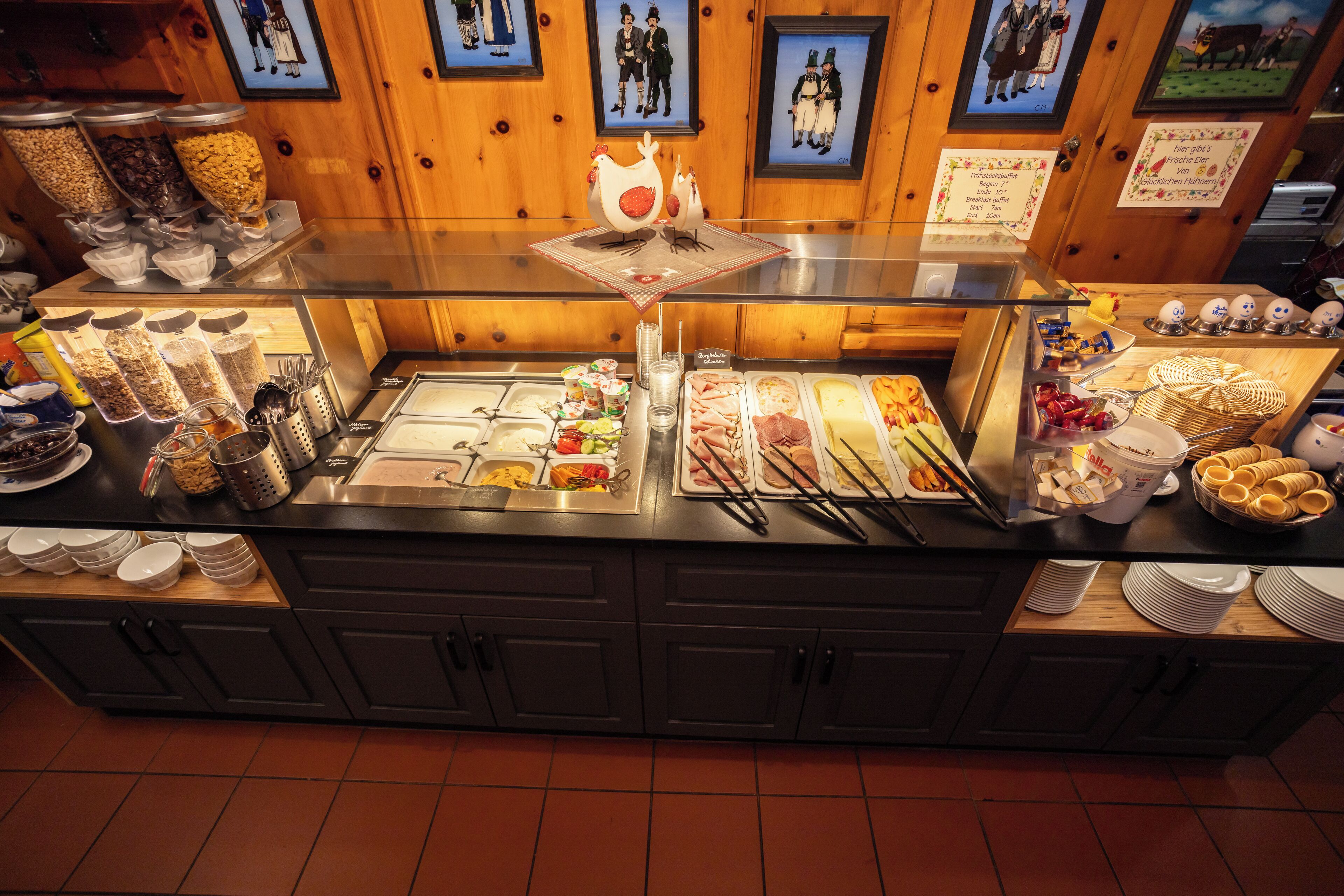 A buffet counter with various food items and condiments.