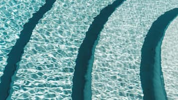 Seasonal outdoor pool, open 9:00 AM to 7:00 PM, pool umbrellas