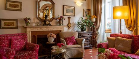 A living room with a fireplace, two sofas, a coffee table, and a lamp.