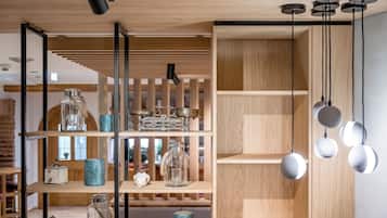 A modern interior with wooden shelves displaying glassware and decorative items.