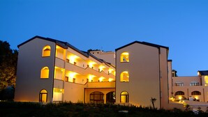 A multi-story hotel with a symmetrical facade, multiple balconies, and a central courtyard. - Hotel Villa Rosa (Martina Franca)