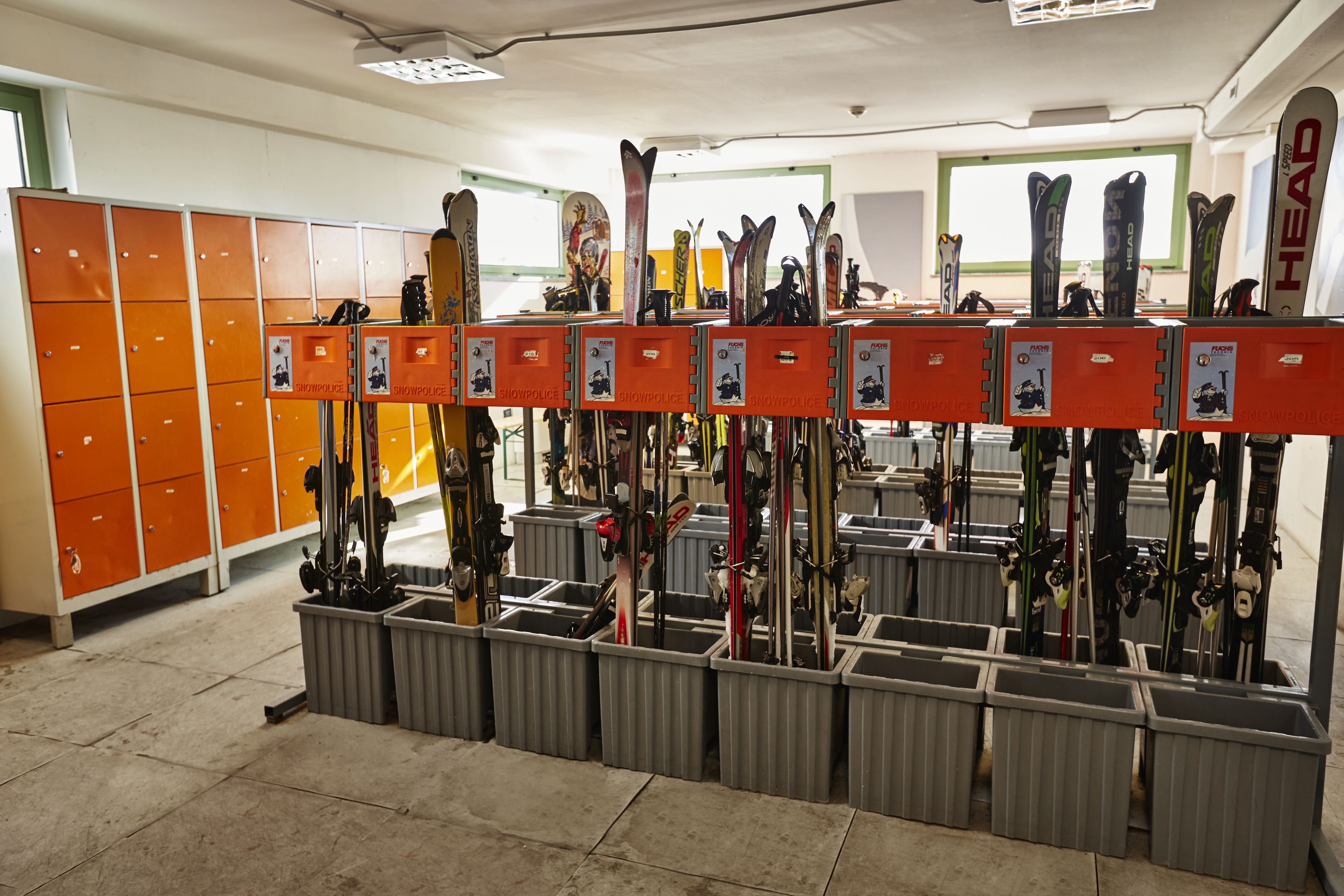 A ski equipment rental shop with multiple ski racks and storage bins.