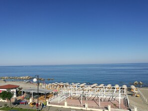 A beachside resort with a pool area, beach umbrellas, and a view of the ocean. - Miramare (Ciro Marina)