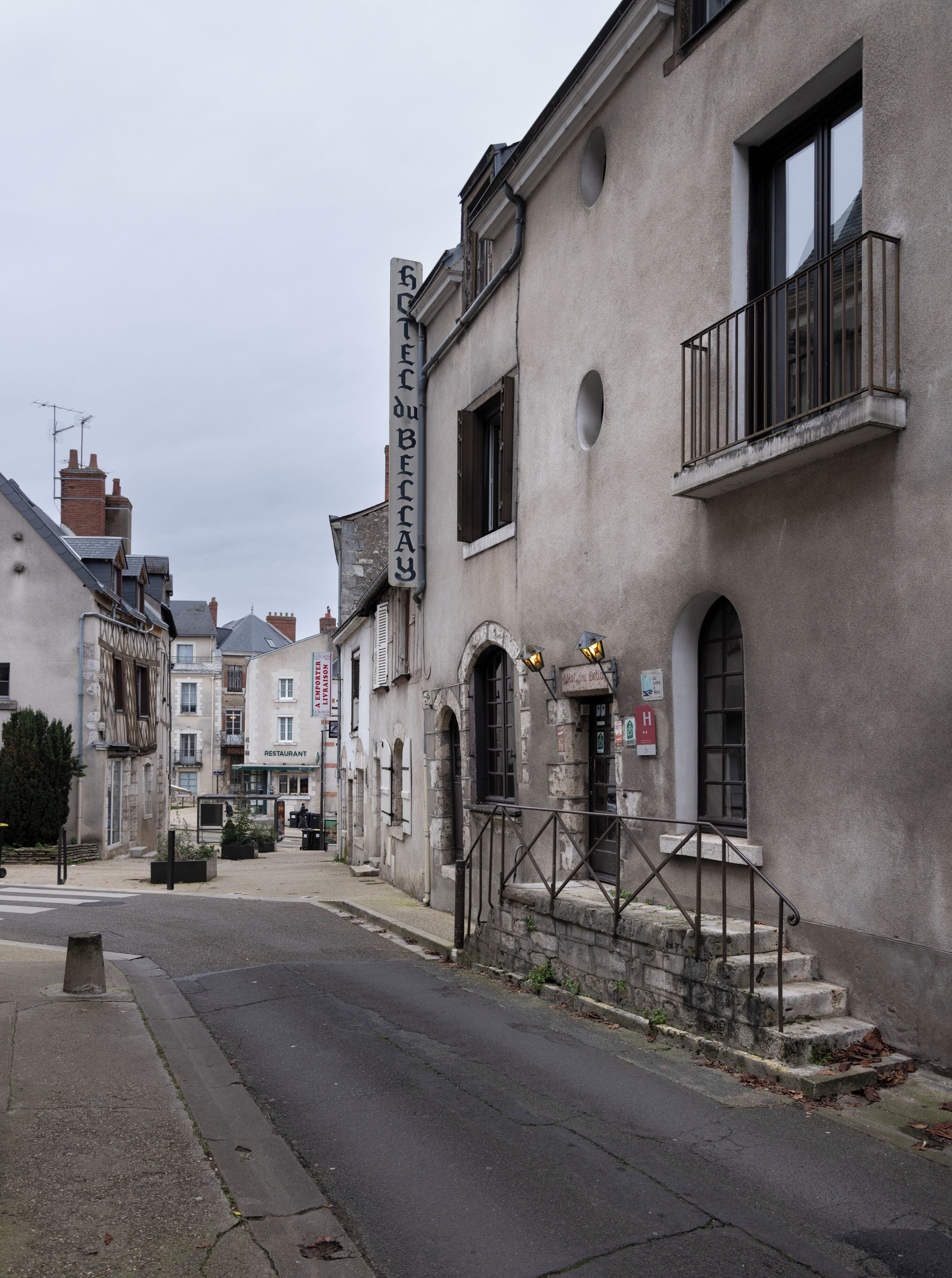 A street view with a building labeled "RESTAURANT" and a sign reading "BOUTIQUE".