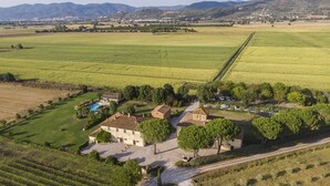 An aerial view of a rural property with multiple buildings, a swimming pool, and surrounding agricultural fields. - Cortona Resort - Le Terre Dei Cavalieri (Cortona)