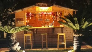 A tiki bar with a pool in the foreground. - Borgo Pida (Misiliscemi)