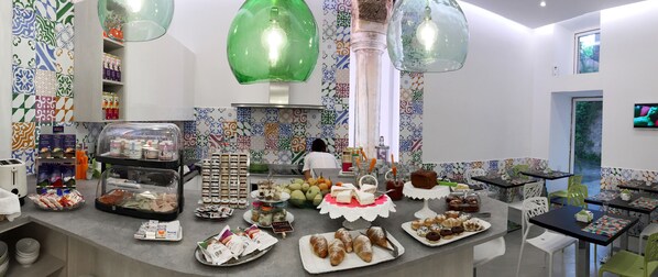 A buffet area with a variety of food items and a person in the background.