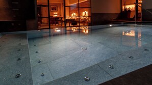 A spacious lobby with a reflective floor, a seating area, and a staircase leading to an upper level. - Hotel Alù (Bormio)