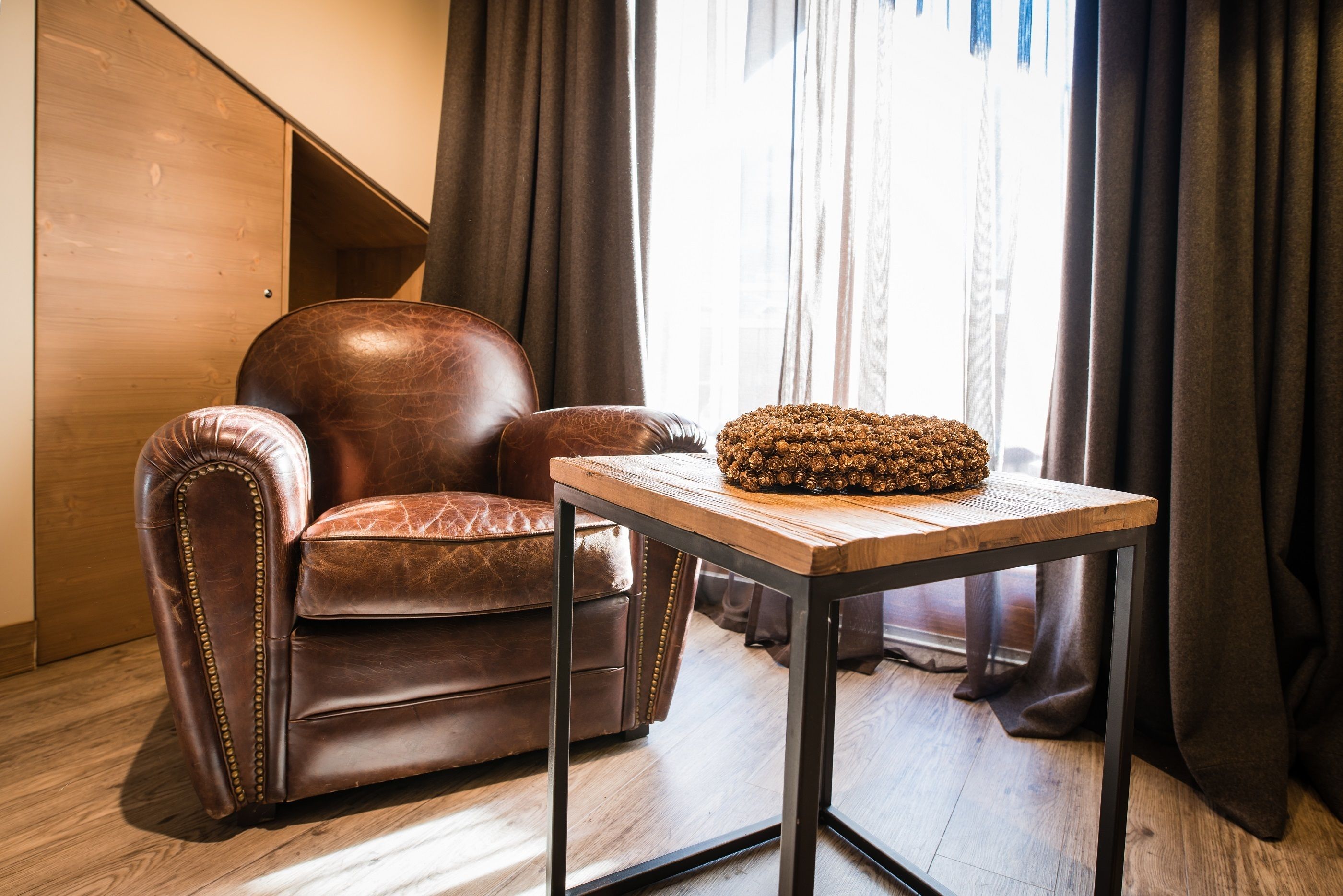 A leather armchair with a wooden table beside it.