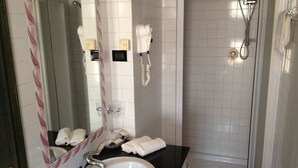 A bathroom with a sink, mirror, hairdryer, and shower. - Mia Hotel Numana (Numana)