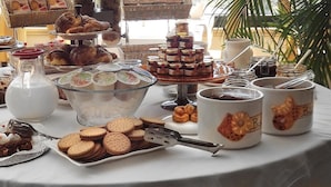 A buffet table with various desserts, including cakes, pastries, and cookies. - Hotel Liolá (Castrocielo)