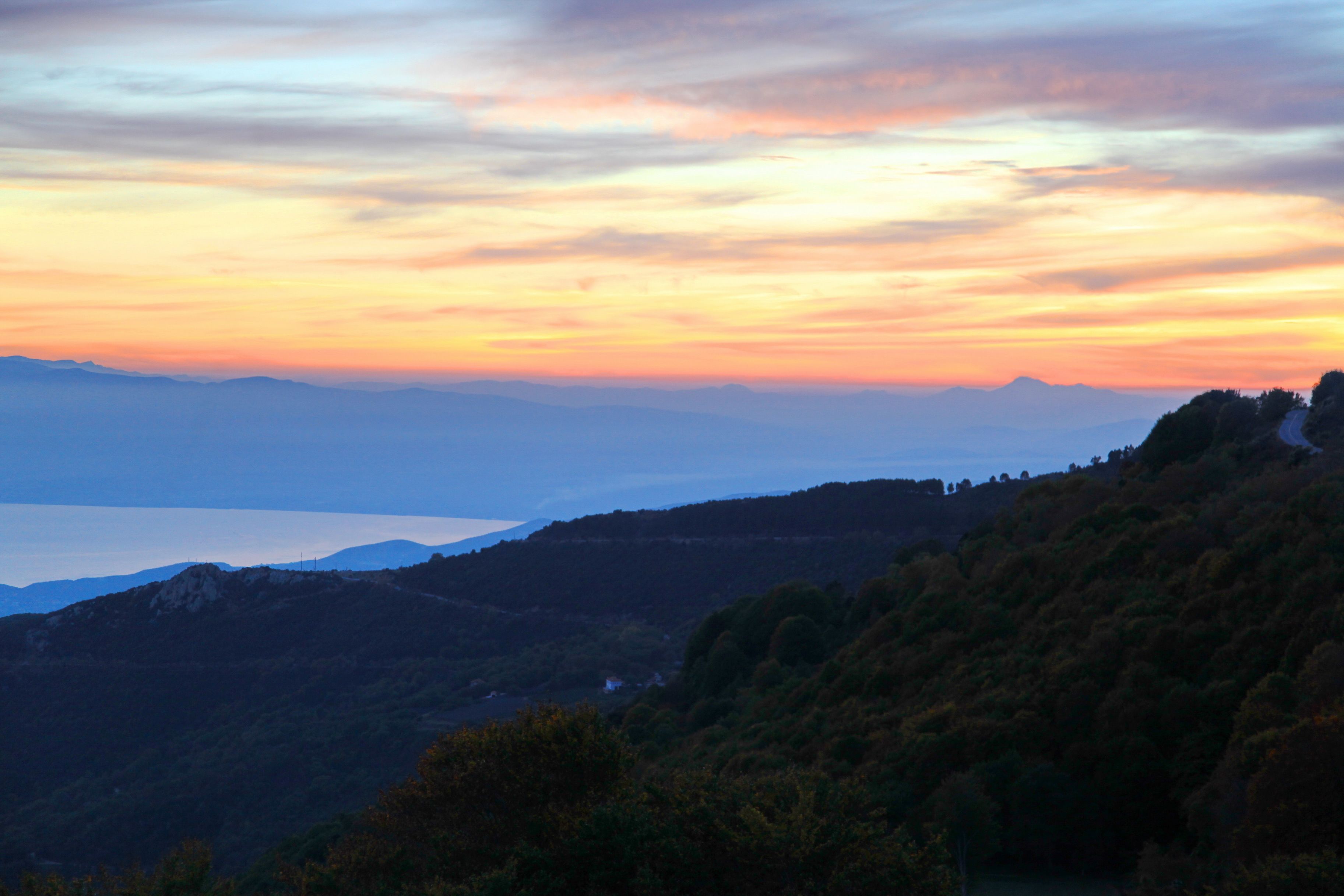 A mountainous landscape with a sunset.