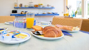 A breakfast table with croissants, juice, and breakfast items. - Albergo Villa Giusto (Barano d'Ischia)