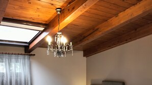 A bedroom with a large bed, a chandelier, a radiator, and a skylight. - Bed & Breakfast De Nittis - Meridia Collection (Barletta)