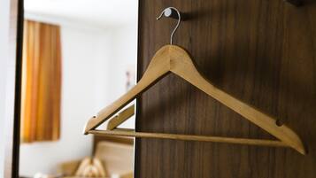A wooden hanger on a wooden door.