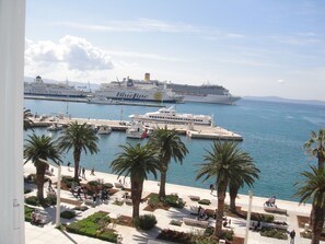 Docked cruise ships line the marina, offering stunning views of the calm water.