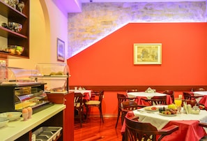 Enjoy a warm and inviting dining experience with comfortable seating and a selection of dishes and condiments.