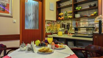 A breakfast buffet with various food items and beverages.