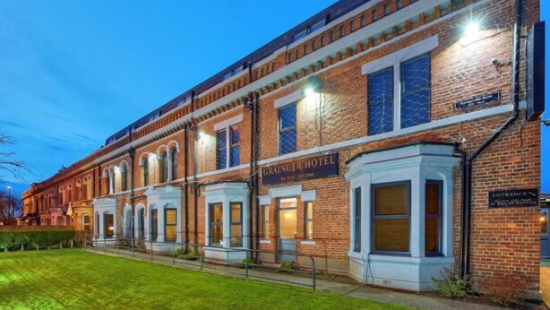 A row of brick buildings with a sign for "Grange Hotel" and "The Old Grange Hotel." - The Grainger Hotel (Newcastle-upon-Tyne)