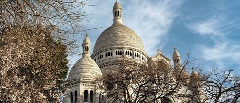 A large, domed building with multiple smaller domes and a central spire, surrounded by bare trees.