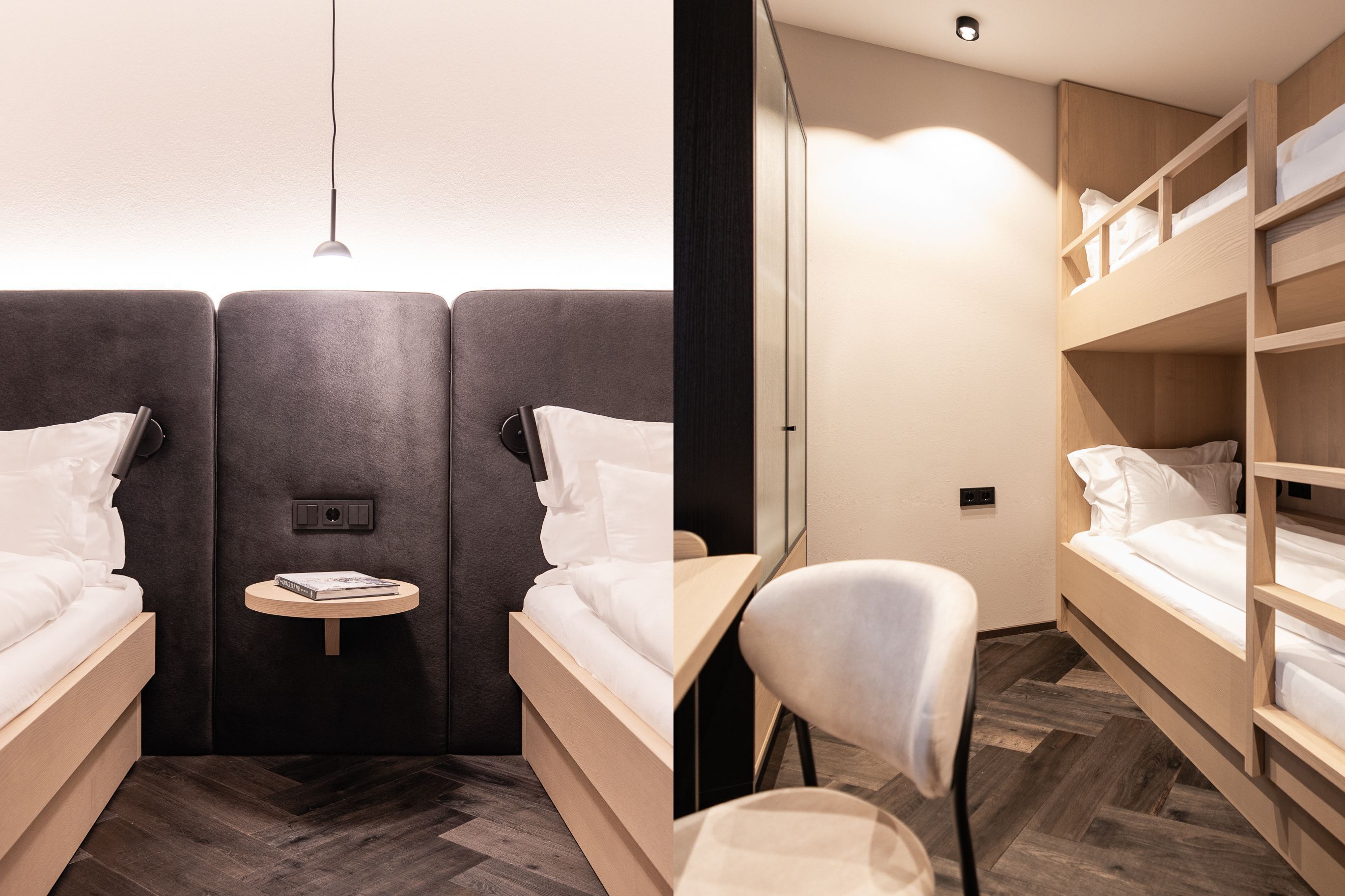 A modern hotel room with two beds, a small table, and a chair.
