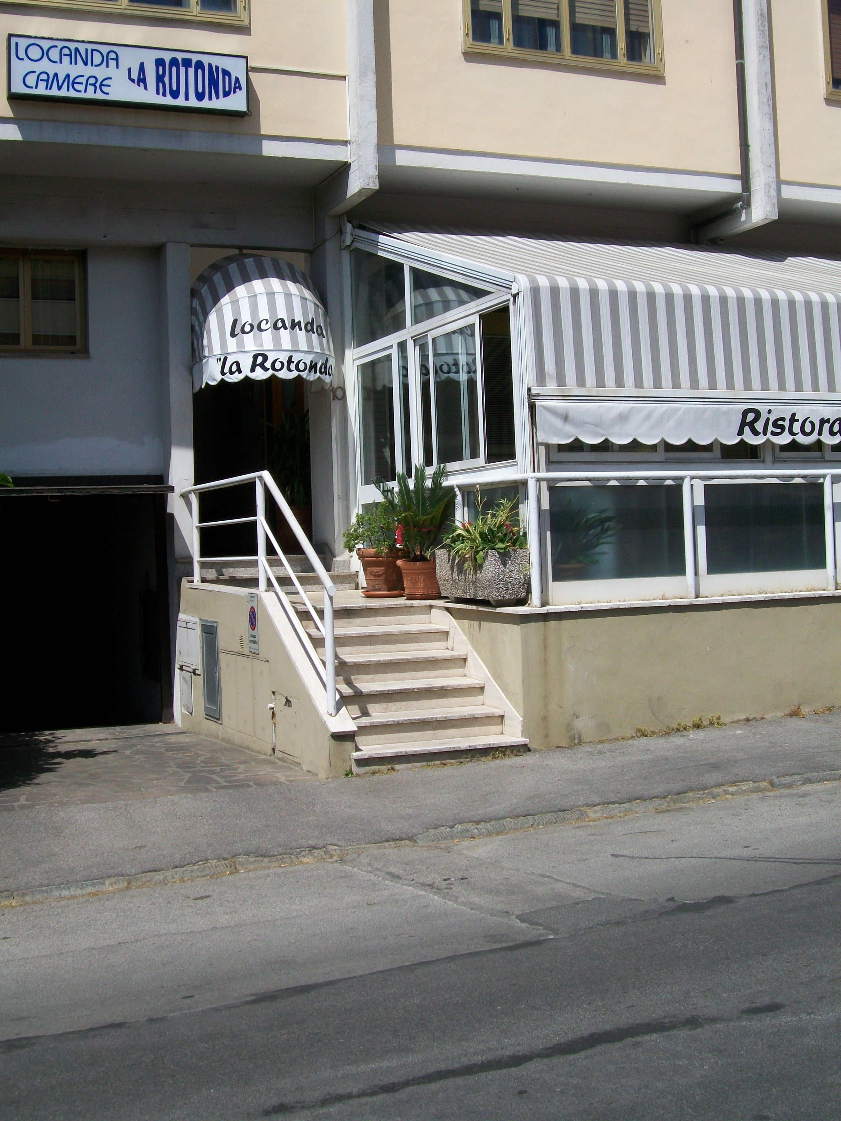 A building with a sign reading "Locanda La Rotonda" and a restaurant named "Ristorante".