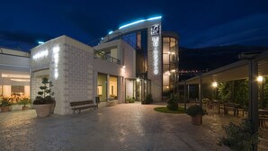 A hotel with a modern design, featuring a courtyard with seating and plants. - Hotel Le Ginestre (Roccacasale)