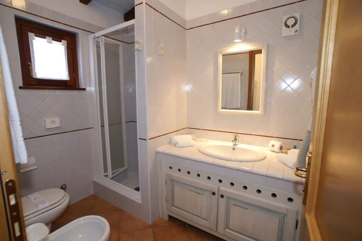 bathtub, hair dryer, bathrobes, bidet