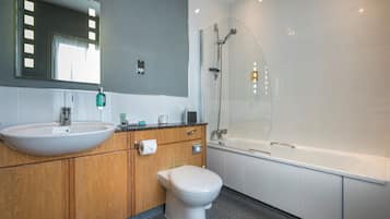 Un baño moderno con lavamanos grande, inodoro y bañera.