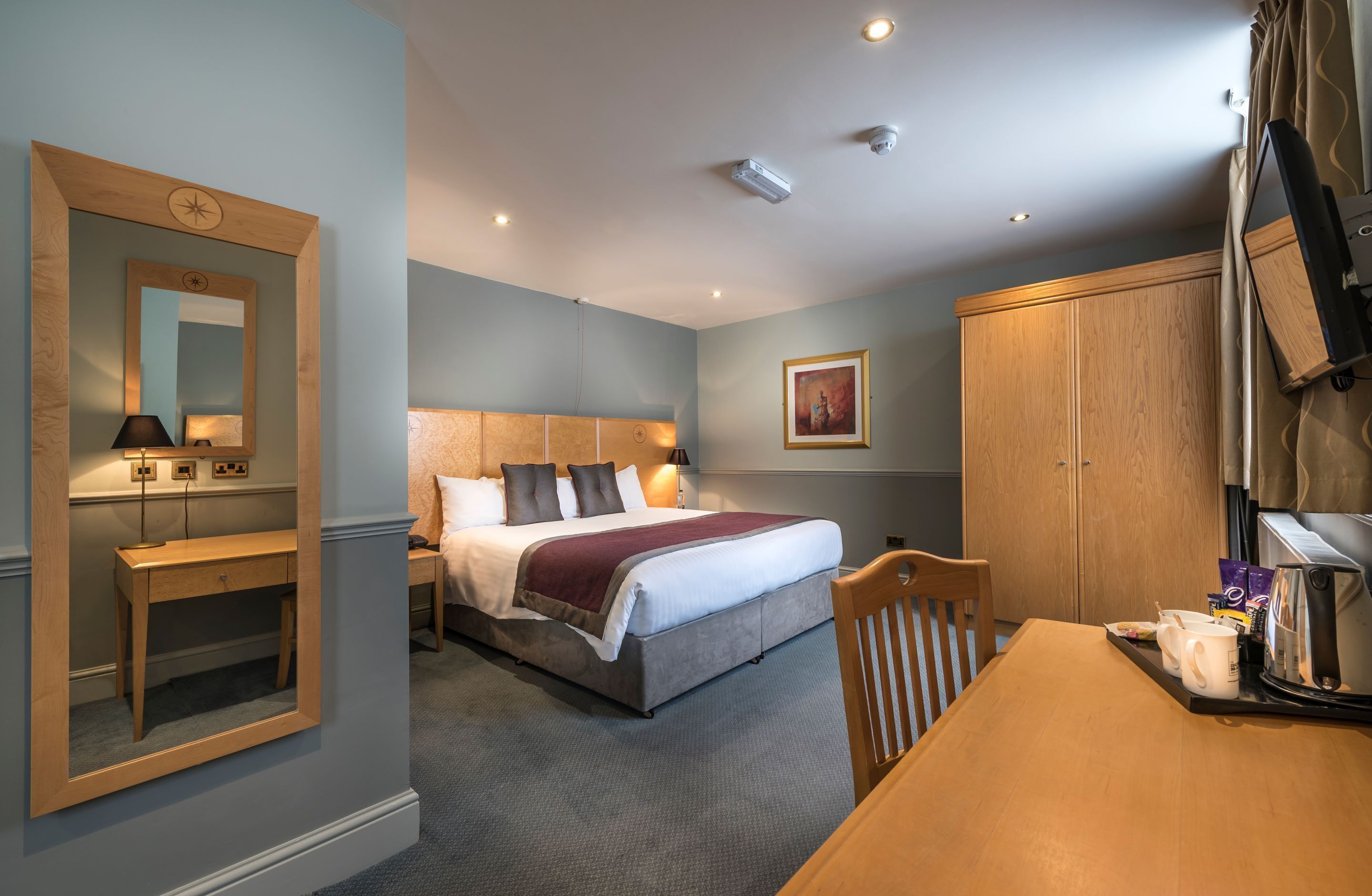 superior family room | premium bedding, desk, blackout curtains, iron/ironing board