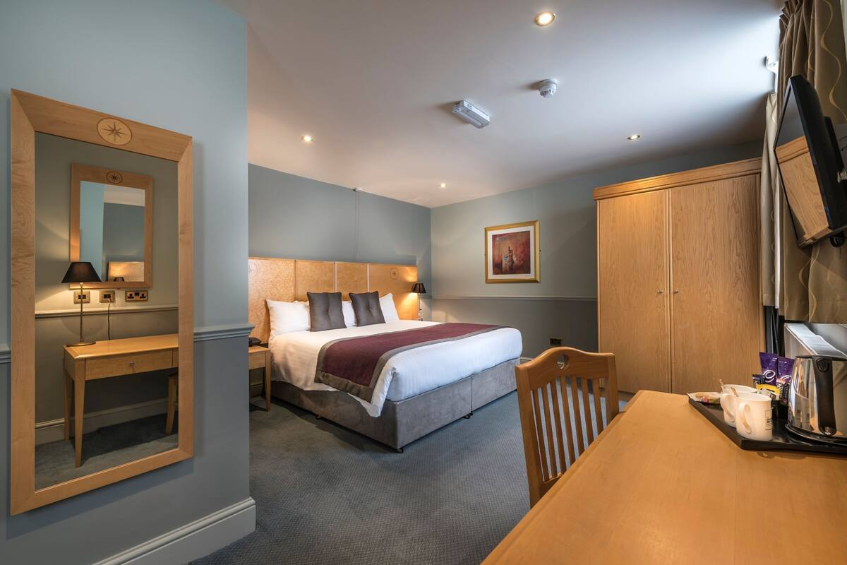 superior family room | premium bedding, desk, blackout curtains, iron/ironing board