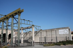 A large industrial building with a sign reading "STAZIONE LEOPOLDA". - La Luna Guesthouse (Florence)