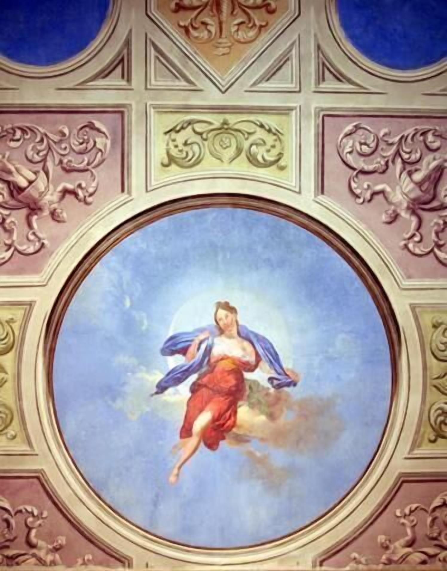 A ceiling with a circular fresco of a woman in a red dress and blue cloak, surrounded by ornate gold and pink decorative elements.