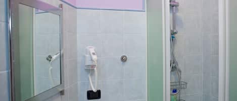 Un baño con ducha, secador de pelo y barra para toallas.