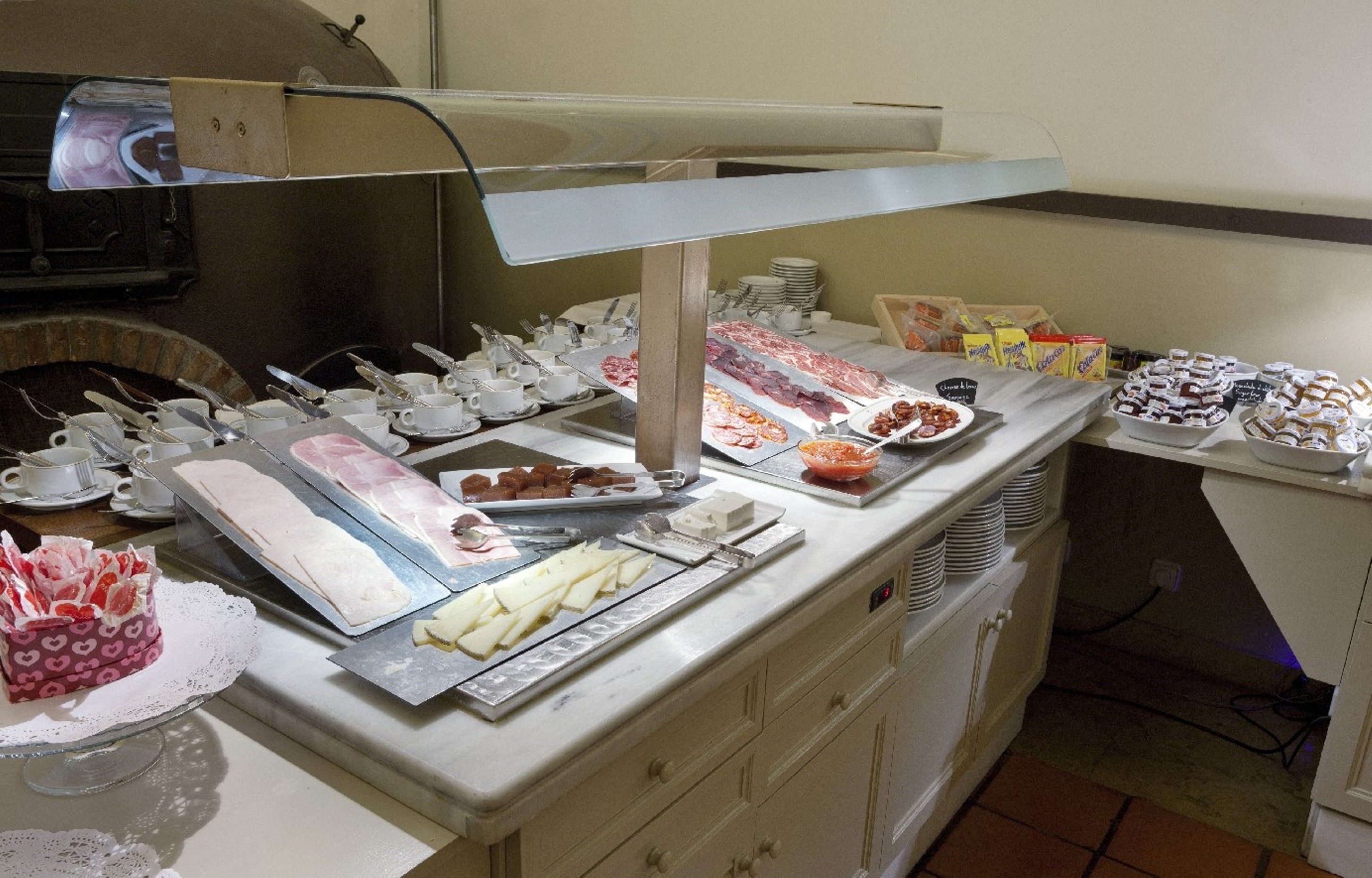 Una mesa de buffet con diversos alimentos y utensilios.