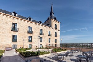 A historic building with a prominent tower and multiple balconies.