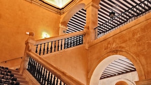 A grand staircase with ornate balustrades and a vaulted ceiling.