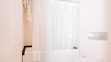A bathroom with a shower, toilet, and a towel rack.