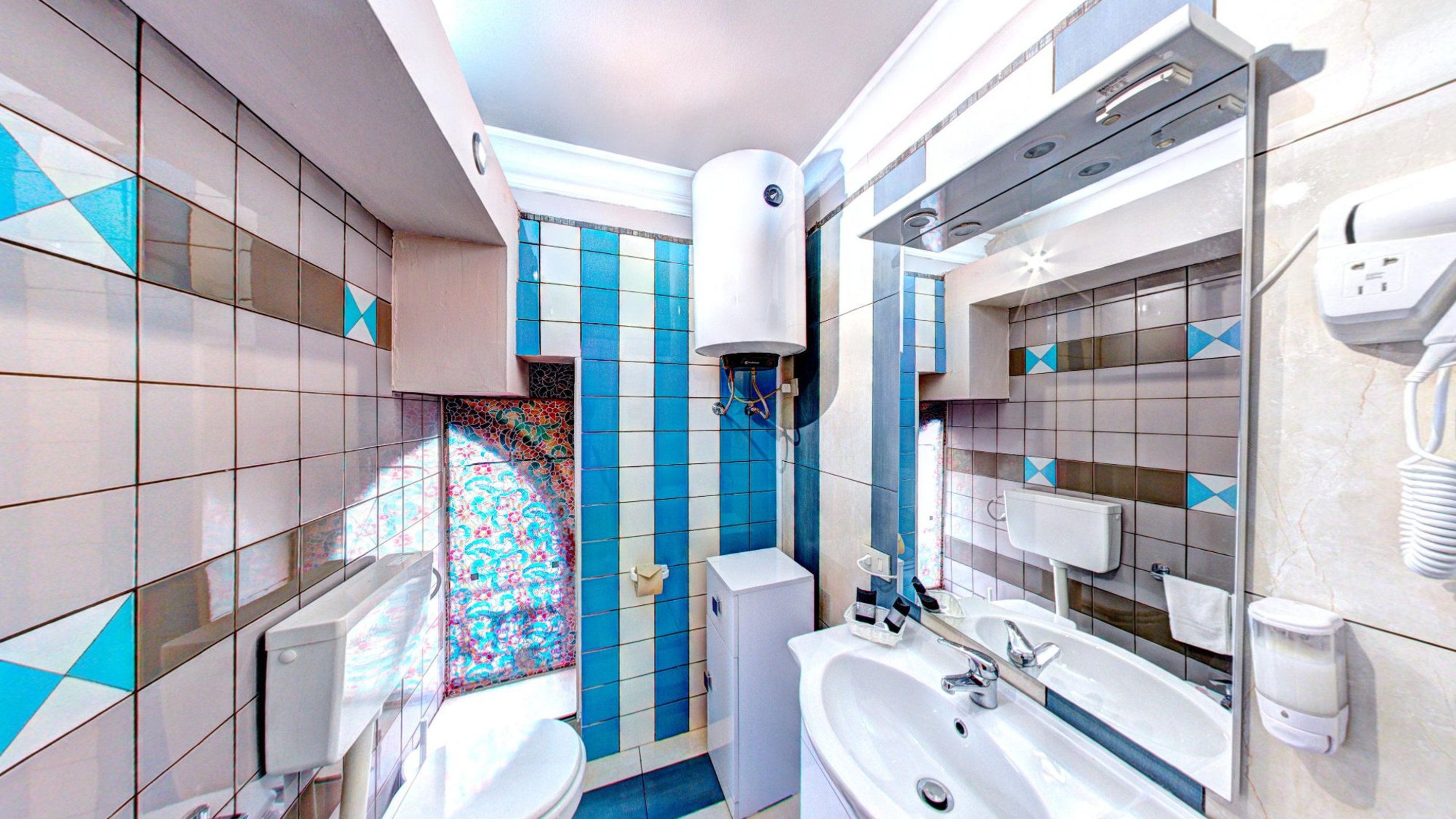 A modern bathroom with a toilet, sink, and shower.