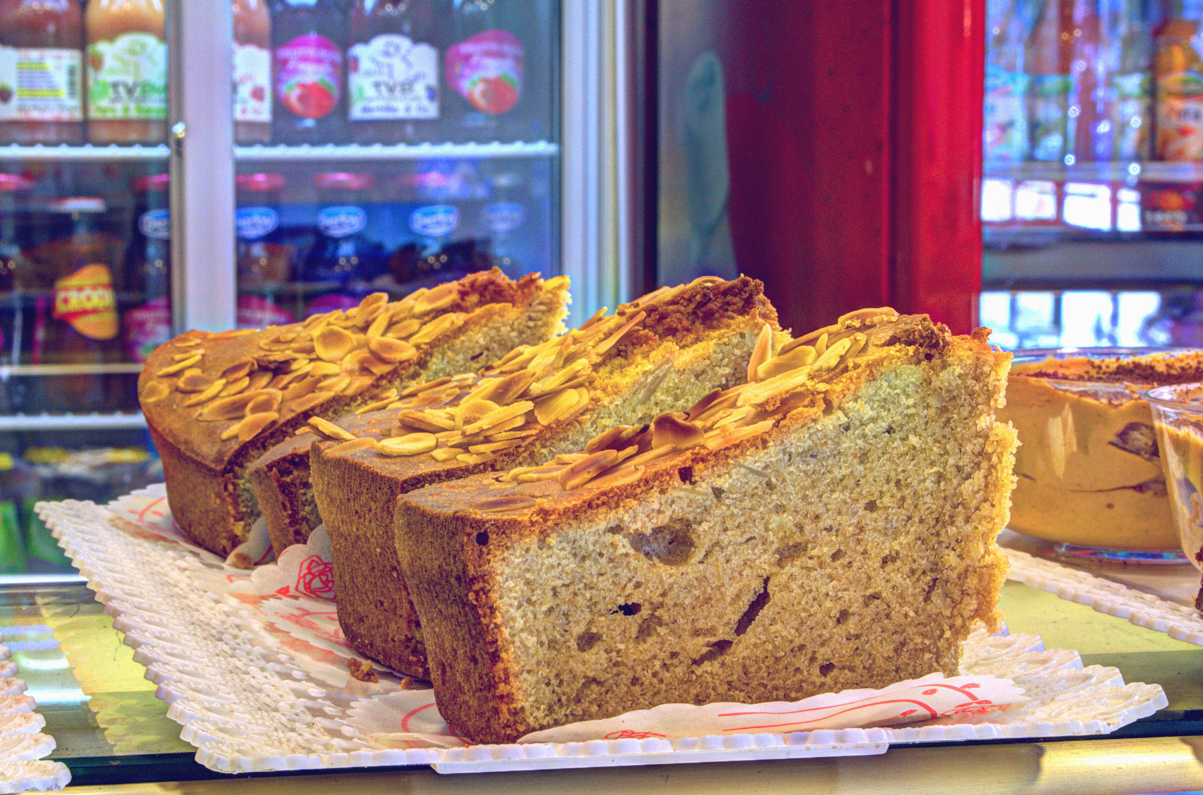 A display of sliced fruitcake in a bakery.