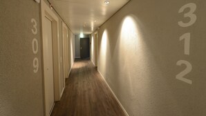 A hallway with doors numbered 309, 310, and 312, leading to rooms. - Hotel du Marche (Lausanne)