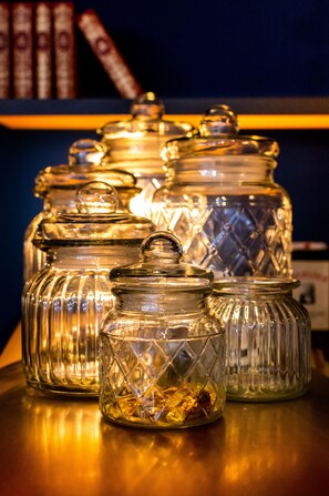 A row of glass jars with lids on a wooden surface. - Best Western Hotel Graslin (Nantes)