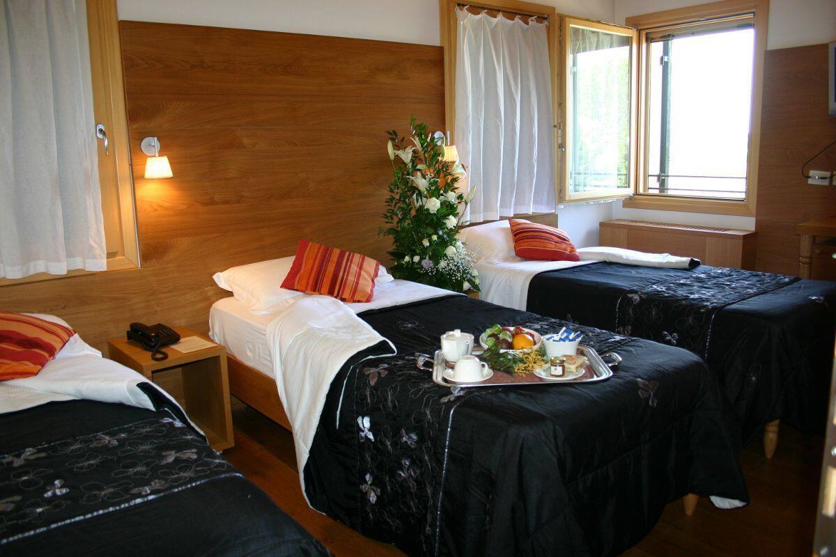 standard triple room, garden view | premium bedding, minibar, in-room safe, desk