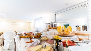A buffet table with various food items and condiments, including cheese, fruits, and bread. - La Pergola (Sant'Agnello)