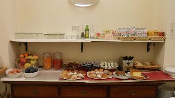A breakfast buffet with various food items and beverages.