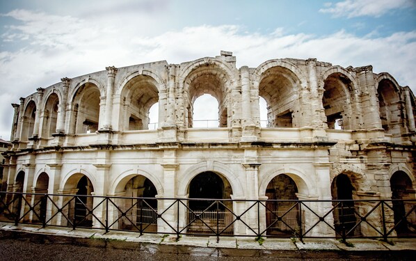 Una estructura antigua de piedra con múltiples arcos y un espacio central abierto.